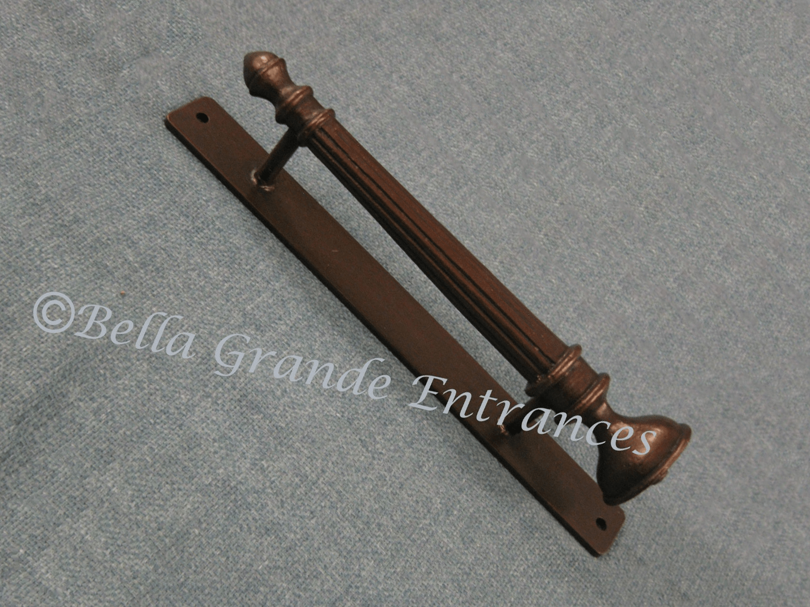 A Crown Top Pull handle 45 degree rotate image on a grey cloth surface