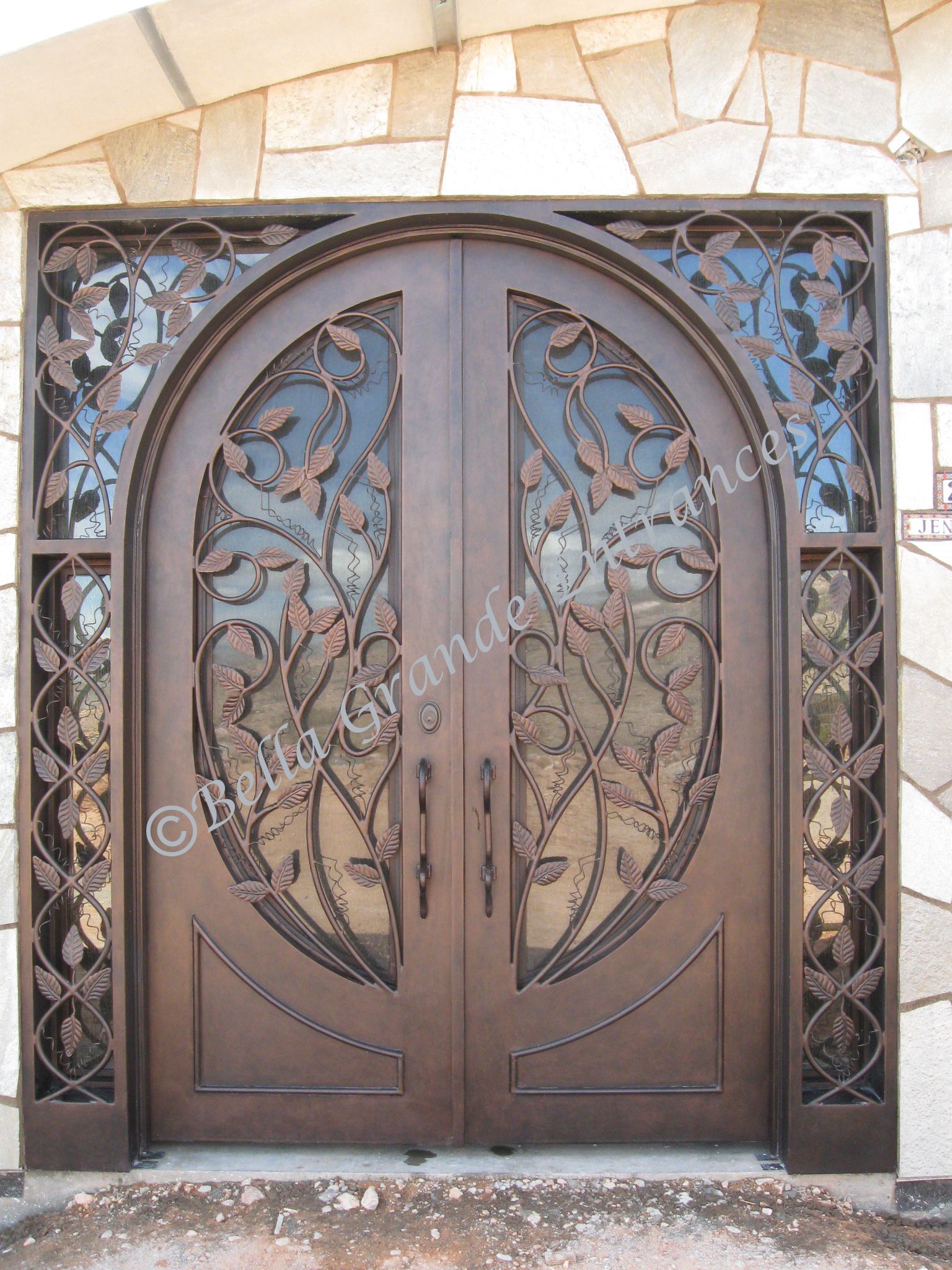 Luxurious iron door featuring a leaf design, installed as the entrance door of a home in Las Vegas.