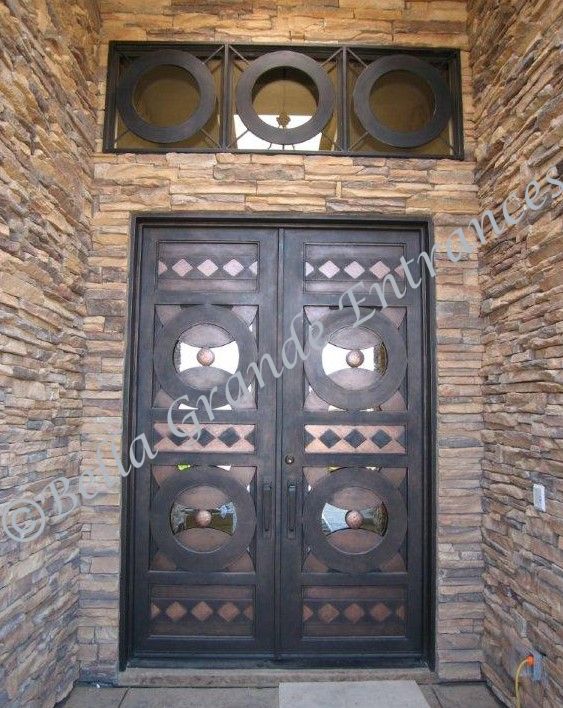 Close-up image of an impressive double iron door and iron grill decorating a house in Las Vegas. Carefully crafted by Bella Grande Entrances.