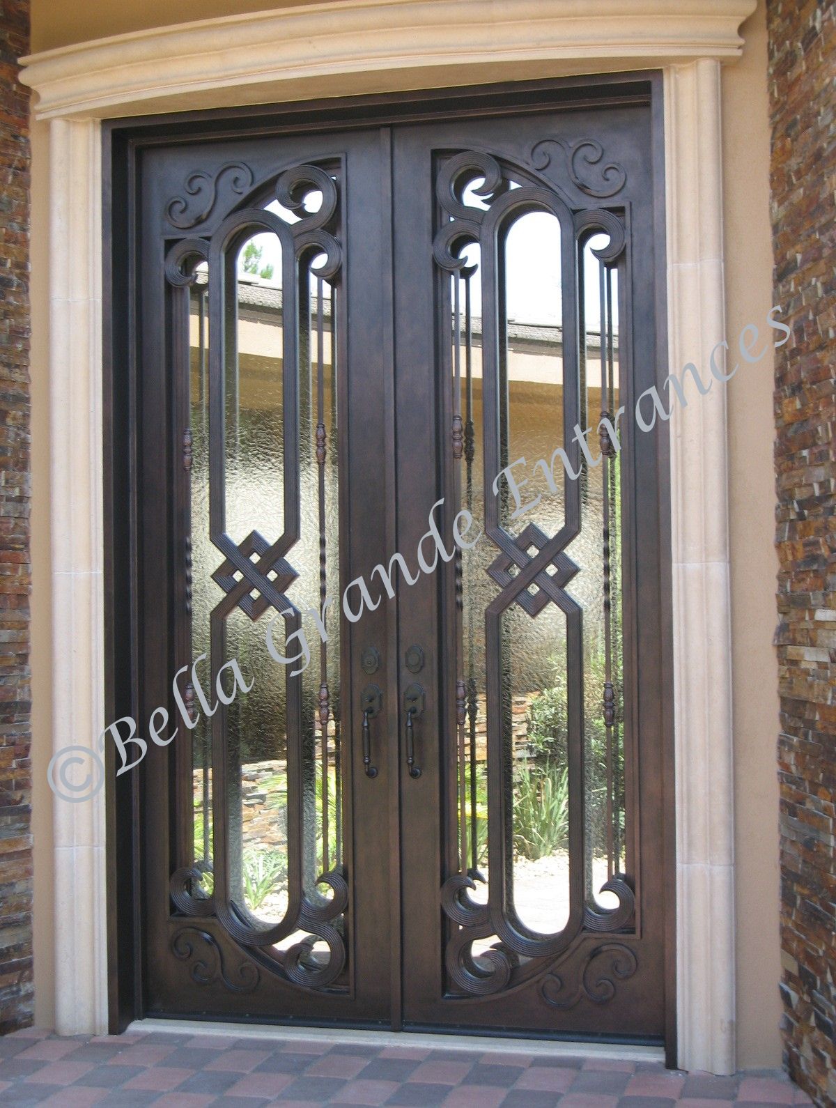 This is a stunning close-up of a beautifully crafted double iron door that graces the entrance of a magnificent house in Las Vegas.