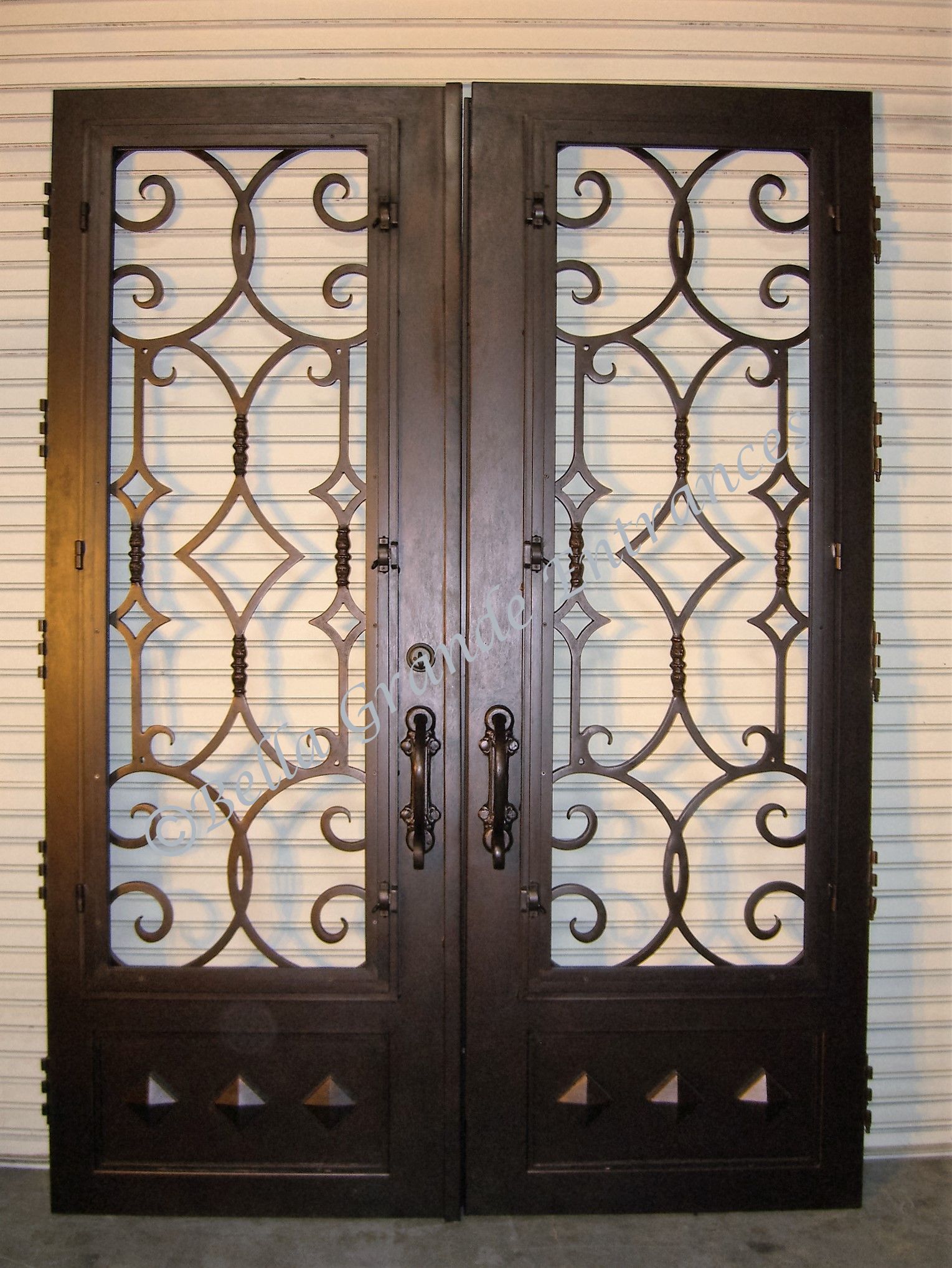 A stunning closeup of a beautifully crafted Double Iron Door, exclusively displayed at the showroom of Bella Grande Entrances in Las Vegas.