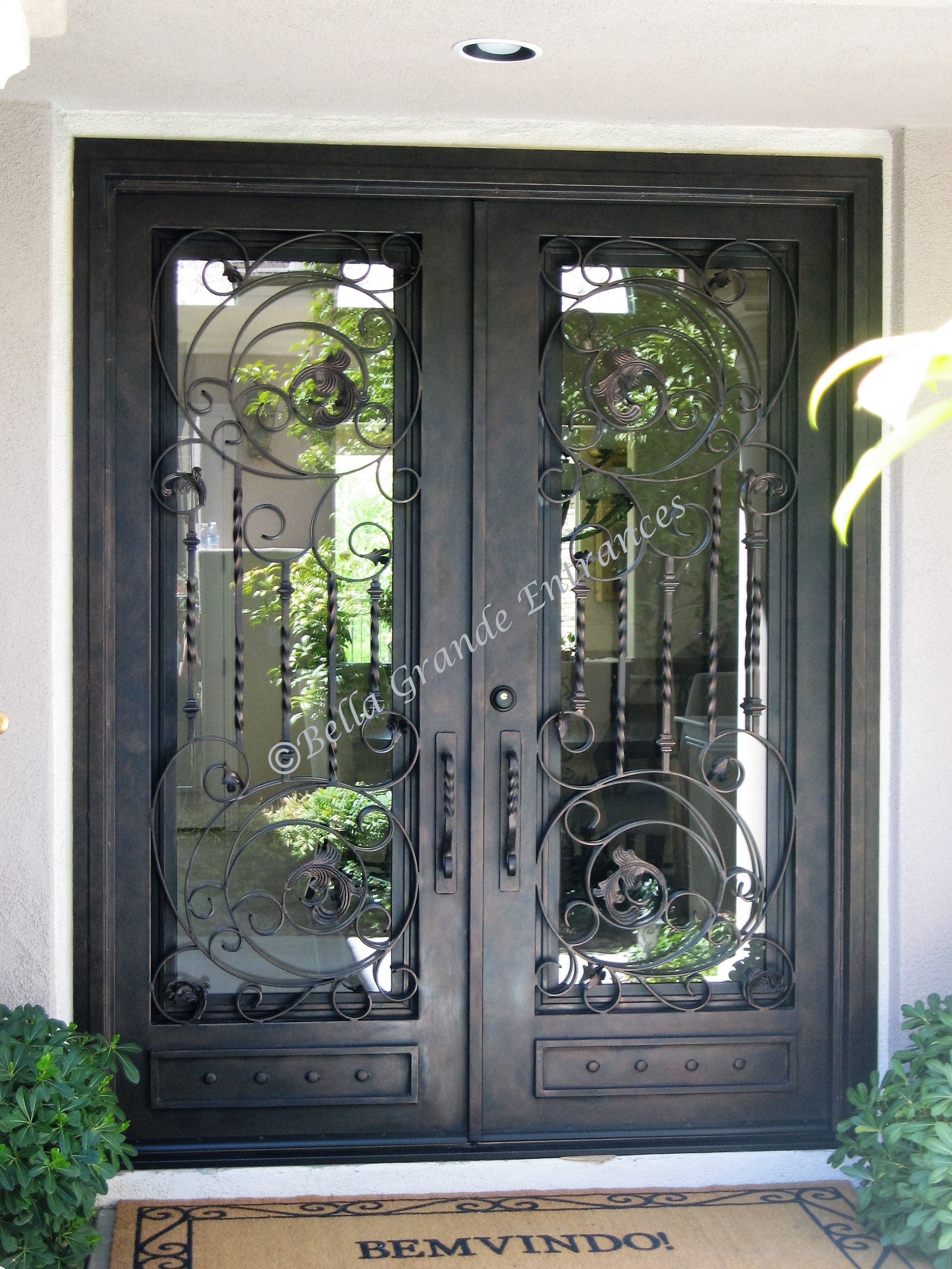 Close-up of stunning, twisted iron door on white house in Las Vegas (by Bella Grande Entrances)