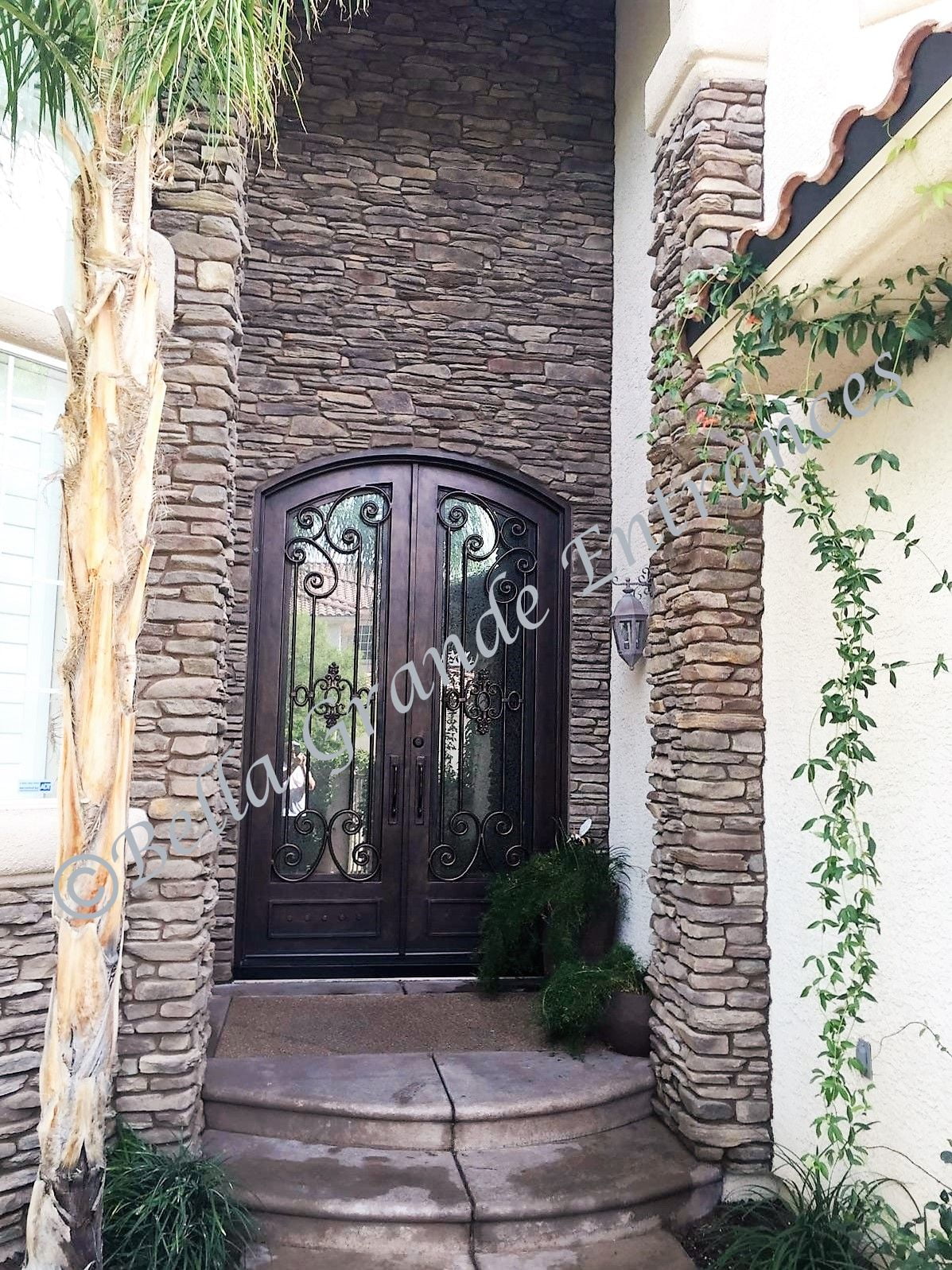 A photo of a stunning double iron door found at a gorgeous house in Las Vegas, crafted by Bella Grande Entrances.