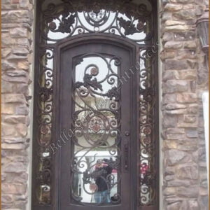 A stunning single door made of wrought iron, featuring a beautiful bronze finish and an elegant glass panel.